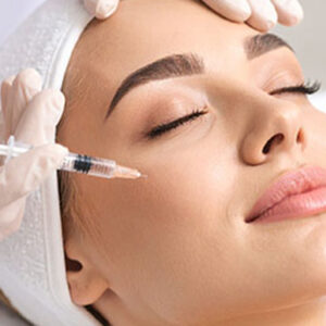 woman smiling laying back with sculptra treatment